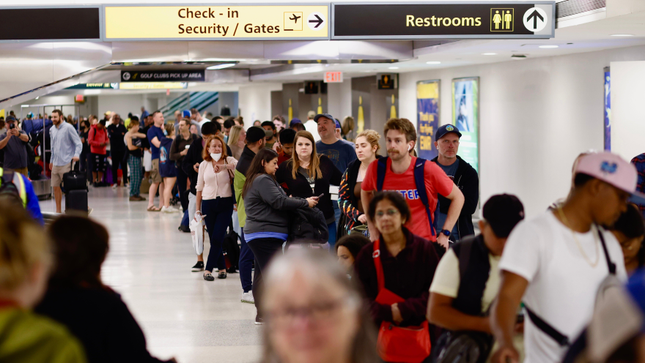 Photo of passengers queuing at Newark Airport. 